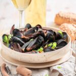 Delicious Irish mussels cooked with white wine sauce and a glass of white wine