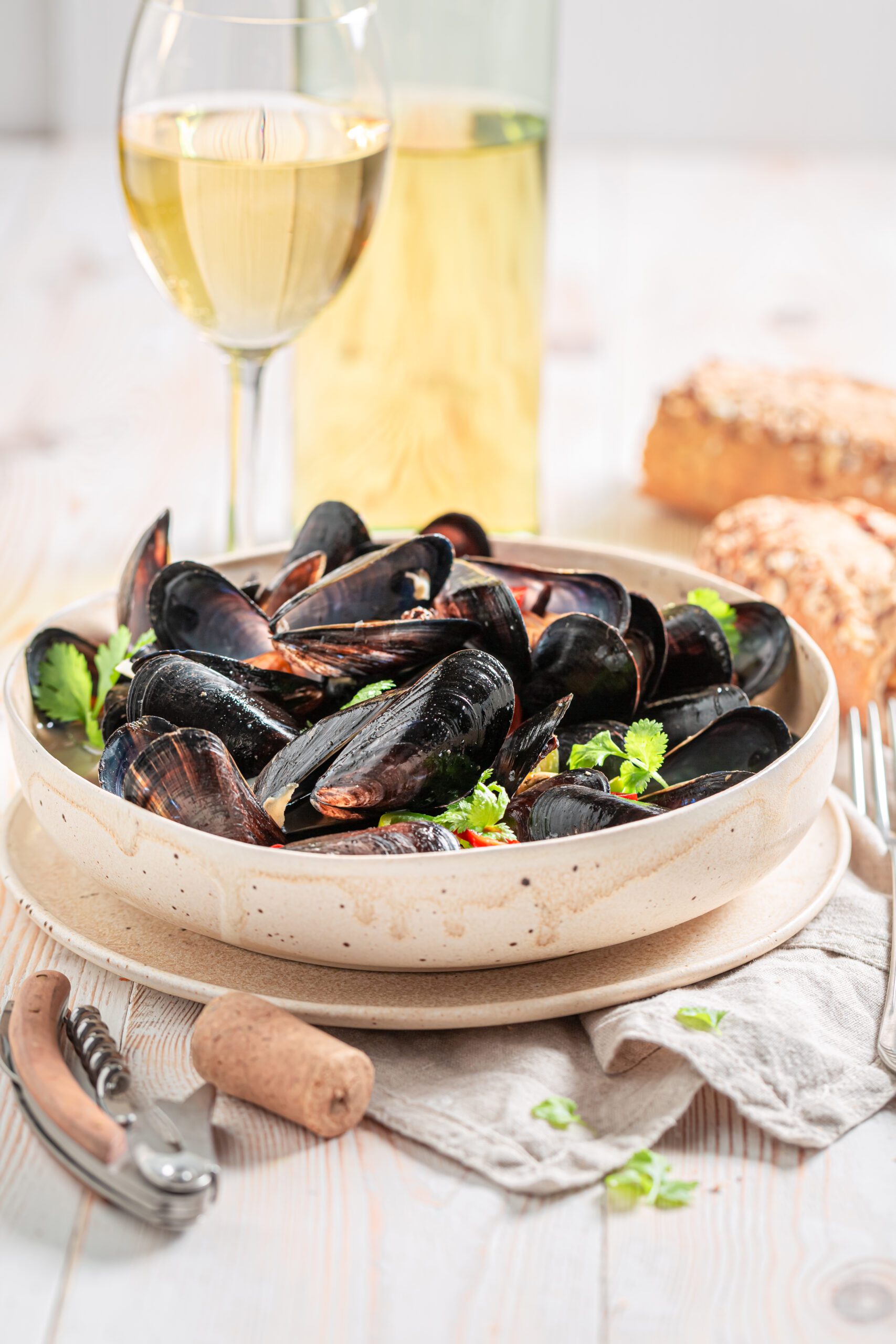 Delicious Irish mussels cooked with white wine sauce and a glass of white wine